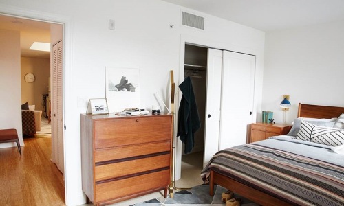 bedroom with bed closet and dresser