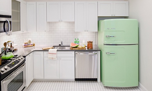 kitchen with white cabinets and a bright green fridge