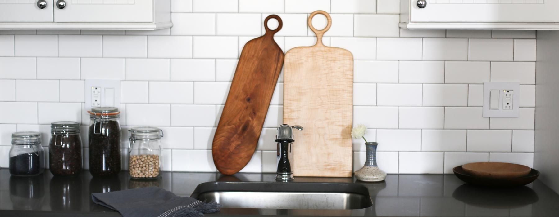 a kitchen sink with cutting boards