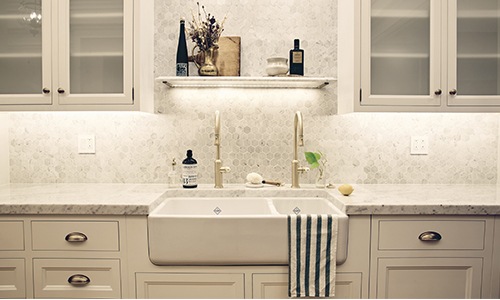 kitchen with farm sink town and white counters and cupboards