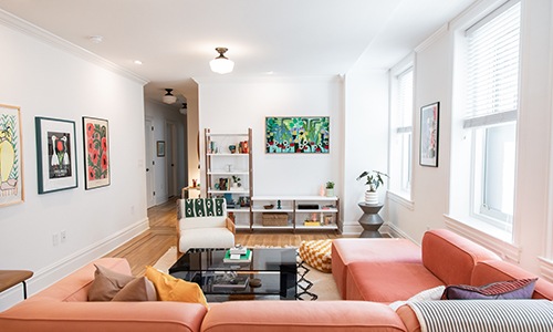 living room with couch chairs and a book shelf