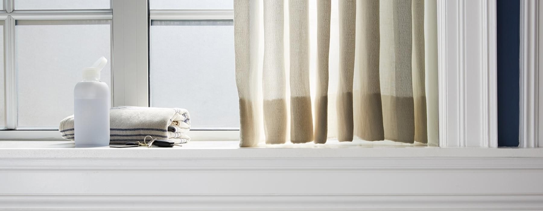 a window with a white curtain