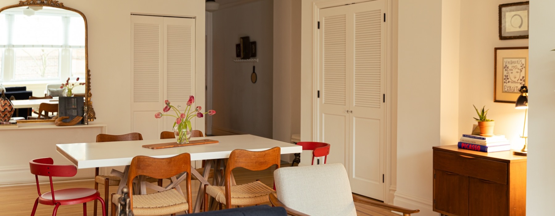 dining table with chairs and mirror on the wall