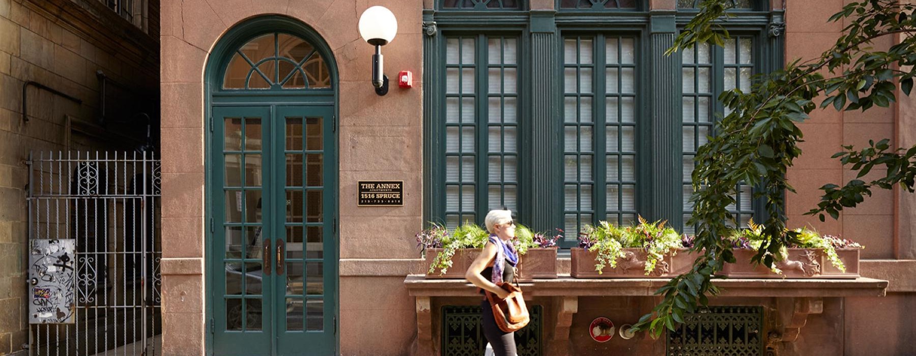 a person walking outside a brick building